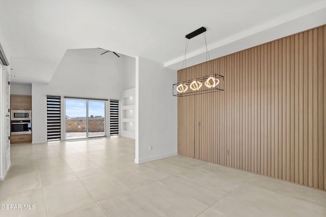 interior space featuring wooden walls and a high ceiling