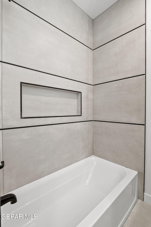 bathroom with a tub to relax in