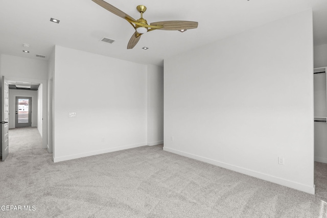 carpeted spare room featuring ceiling fan