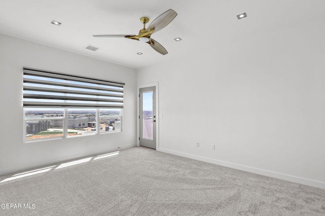 carpeted empty room featuring ceiling fan