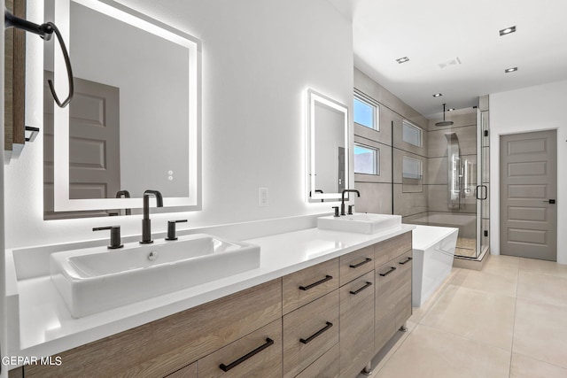 bathroom with tile patterned floors, separate shower and tub, and vanity