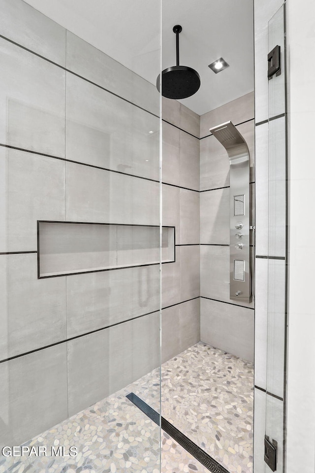 bathroom with tiled shower