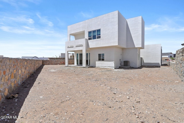 rear view of house featuring central air condition unit