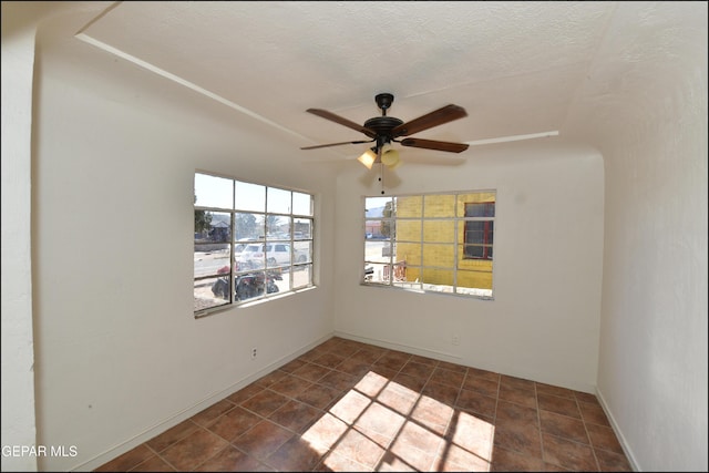 empty room featuring ceiling fan and a textured ceiling