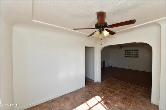 unfurnished room featuring a textured ceiling and ceiling fan