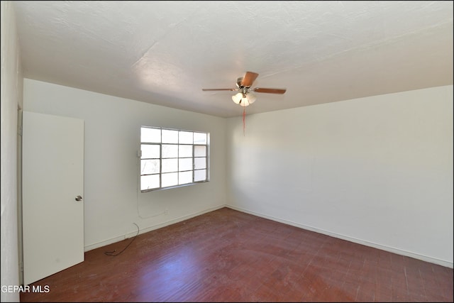 unfurnished room with ceiling fan, dark hardwood / wood-style floors, and a textured ceiling