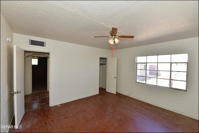 interior space featuring ceiling fan, dark hardwood / wood-style floors, a textured ceiling, and a closet