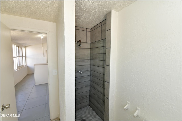 bathroom with tiled shower, tile patterned floors, and a textured ceiling