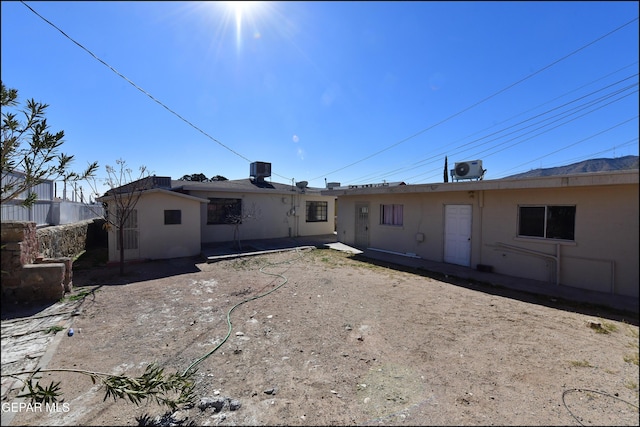 rear view of house with central AC unit