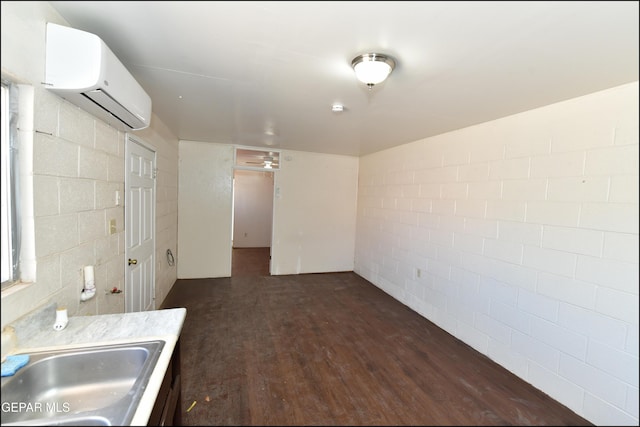 interior space featuring an AC wall unit, sink, and dark hardwood / wood-style flooring