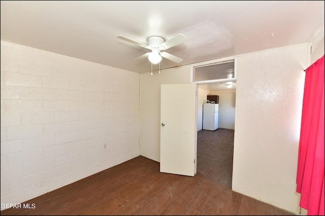 unfurnished room with ceiling fan and dark hardwood / wood-style flooring