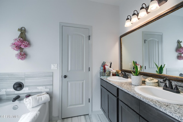 bathroom with vanity and a bathtub