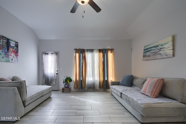 living room featuring ceiling fan and vaulted ceiling