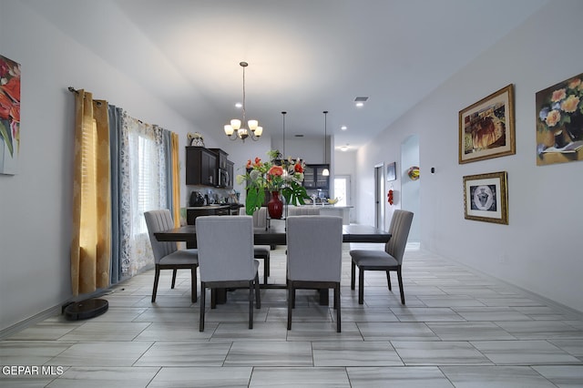 dining space with plenty of natural light and an inviting chandelier