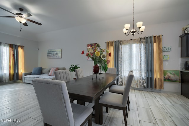 dining area featuring ceiling fan with notable chandelier and a wealth of natural light