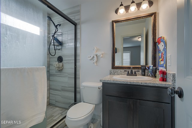 bathroom with walk in shower, vanity, toilet, and a wealth of natural light