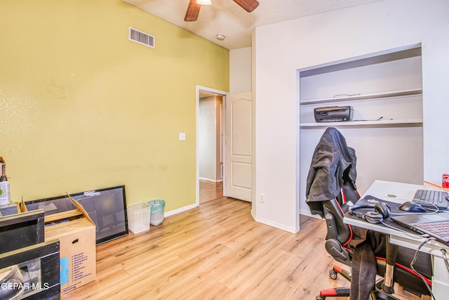 office space with a textured ceiling, light hardwood / wood-style flooring, and ceiling fan