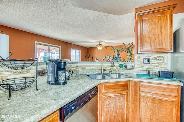 kitchen with sink, dishwasher, ceiling fan, a textured ceiling, and decorative backsplash