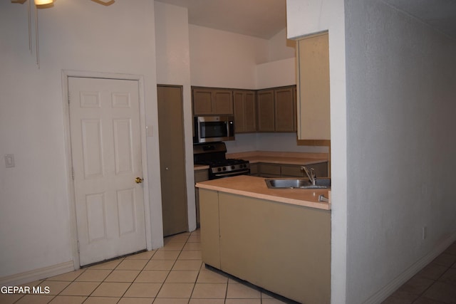 kitchen with ceiling fan, appliances with stainless steel finishes, sink, and light tile patterned floors