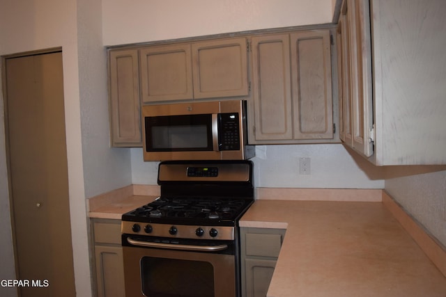 kitchen featuring stainless steel appliances and light brown cabinetry