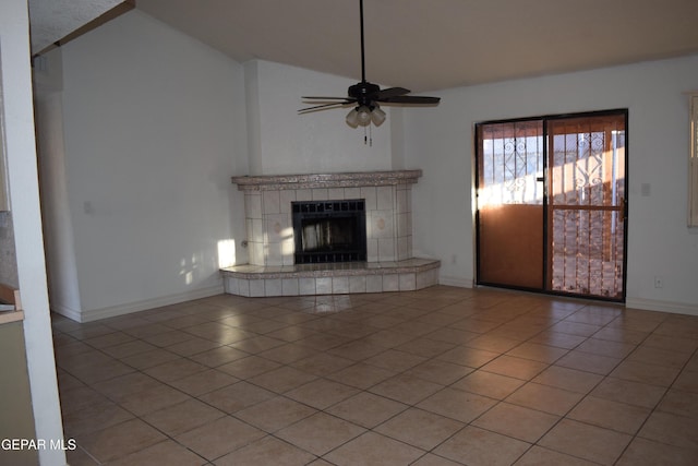 unfurnished living room with light tile patterned floors, a fireplace, ceiling fan, and vaulted ceiling