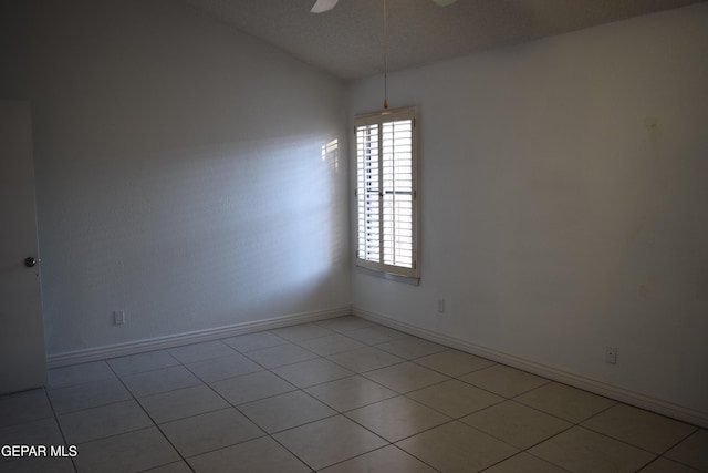 spare room featuring vaulted ceiling and ceiling fan