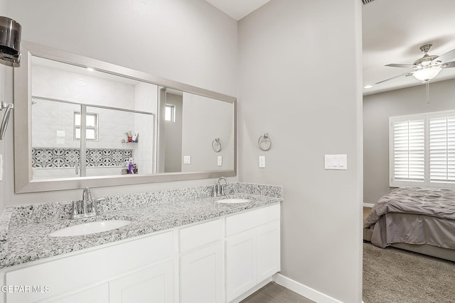 bathroom featuring a shower with door, vanity, and ceiling fan