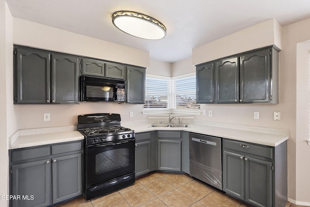 kitchen featuring gray cabinetry, sink, light tile patterned floors, and black appliances