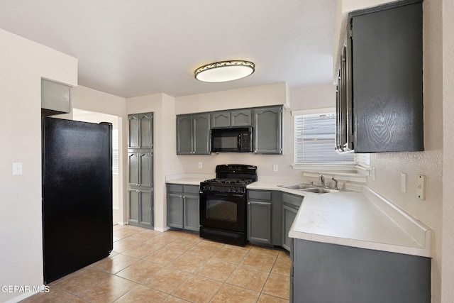 kitchen featuring gray cabinets, light tile patterned flooring, sink, and black appliances