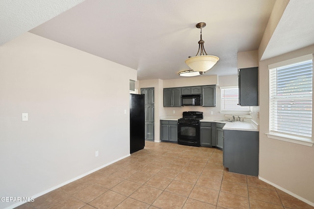 kitchen with gray cabinets, sink, hanging light fixtures, light tile patterned floors, and black appliances