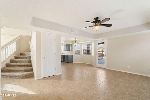 unfurnished living room with ceiling fan and light tile patterned floors