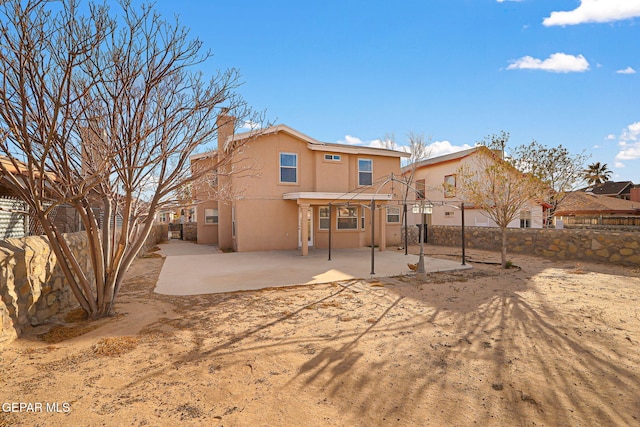 back of property with a patio