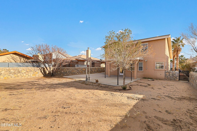 rear view of house featuring a patio