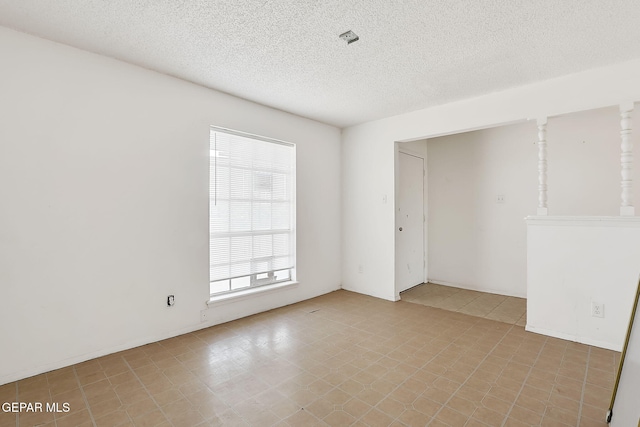 empty room with a textured ceiling