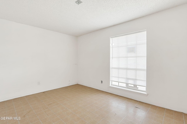 empty room featuring a textured ceiling