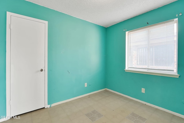 empty room with a textured ceiling