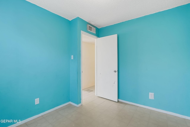 empty room featuring a textured ceiling