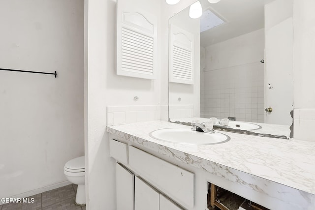 bathroom featuring walk in shower, vanity, and toilet