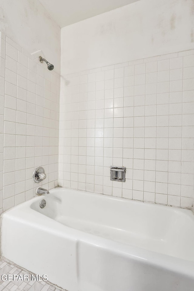 bathroom with tile patterned flooring and tiled shower / bath combo