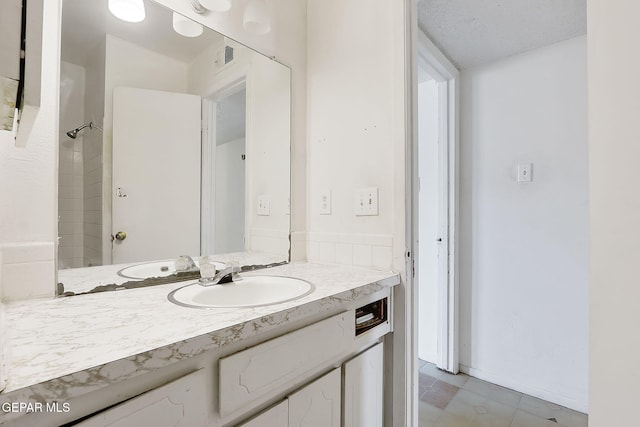 bathroom featuring vanity and walk in shower