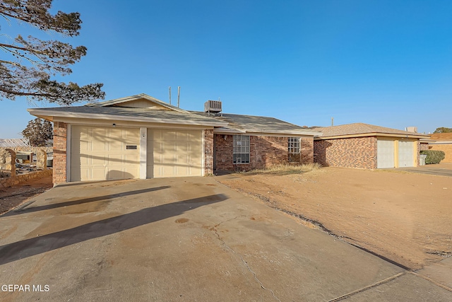 ranch-style house with central AC and a garage