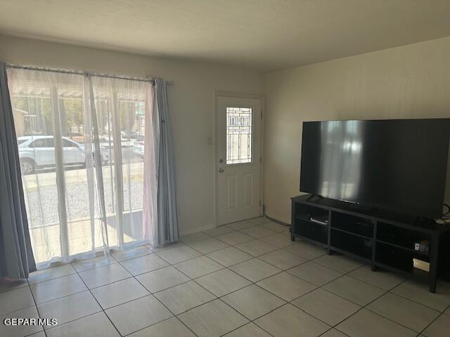 unfurnished living room with light tile patterned floors