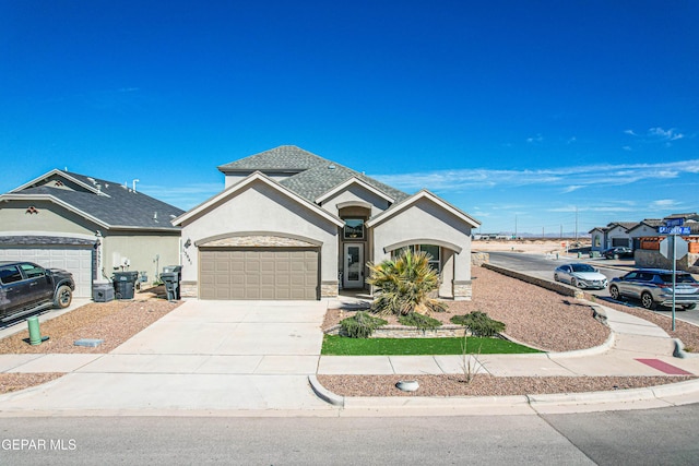 view of front of property featuring a shingled roof, concrete driveway, an attached garage, and stucco siding