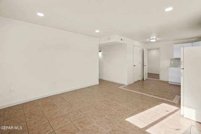 unfurnished room with light tile patterned flooring