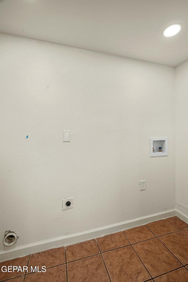 clothes washing area featuring tile patterned floors, washer hookup, and hookup for an electric dryer