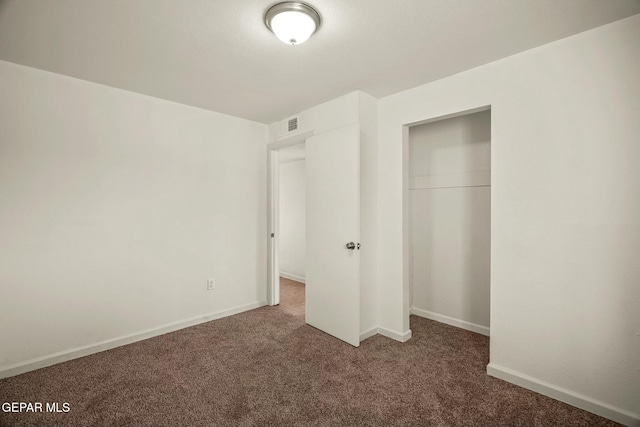 unfurnished bedroom with a closet and carpet flooring