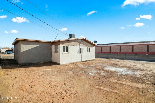 rear view of house featuring central AC