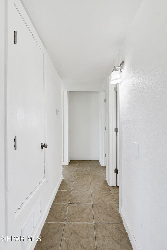 241 Mango Rd, El Paso, TX 79915 - hall featuring baseboards and light tile patterned floors
