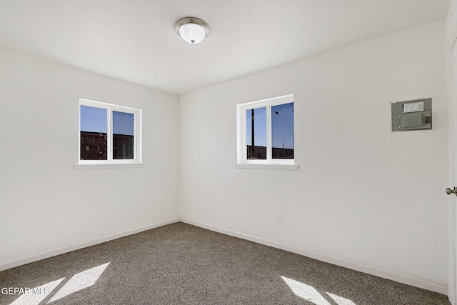 241 Mango Rd, El Paso, TX 79915 - empty room with carpet flooring, baseboards, a healthy amount of sunlight, and electric panel