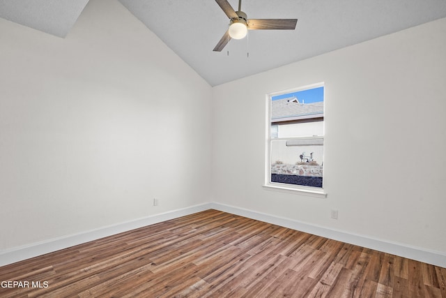 spare room featuring wood-type flooring, vaulted ceiling, and ceiling fan